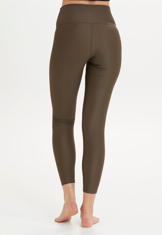 Athlecia Skinny Sportbroek 'Cadidell' in Bruin