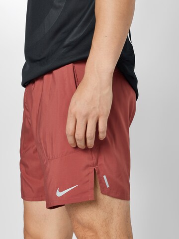 NIKE Regular Workout Pants 'Flex Stride' in Red