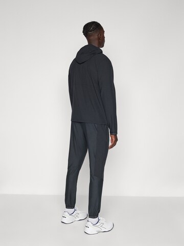 Sergio Tacchini Zwężany krój Spodnie sportowe 'Pelle' w kolorze czarny