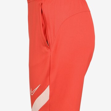 NIKE Tapered Workout Pants in Red