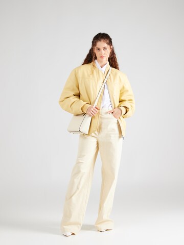 REMAIN Prehodna jakna | rumena barva
