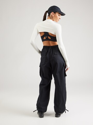 Largi Pantaloni cu buzunare de la Nike Sportswear pe negru