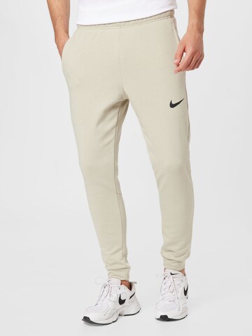 NIKE Workout Pants in Beige: front