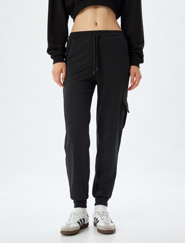 Koton Tapered Trousers in Black: front