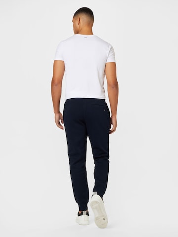 TOMMY HILFIGER Tapered Housut värissä sininen