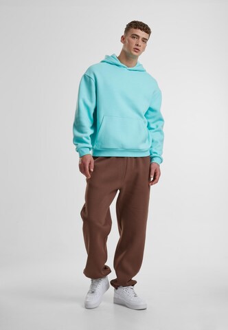 Tapered Pantaloni di Urban Classics in marrone