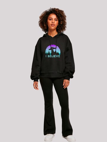 Sweat-shirt 'I Believe UFO Alien Raumschiff Retro' F4NT4STIC en noir