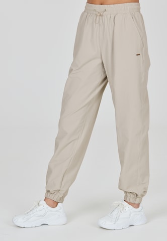 Athlecia Regular Workout Pants 'Hero' in Beige: front