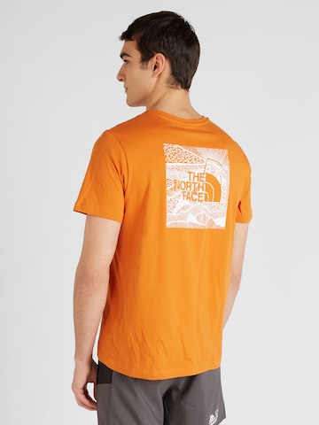 THE NORTH FACE T-Shirt 'REDBOX CELEBRATION' in Orange: predná strana