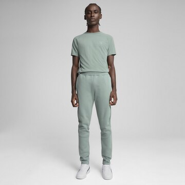 PUMA Slim fit Sports trousers 'Evostripe' in Green
