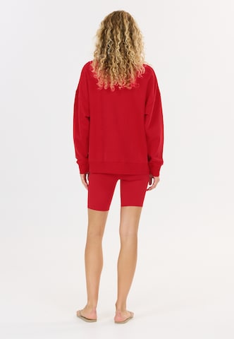 Athlecia Slim fit Sports trousers 'Blossom' in Red