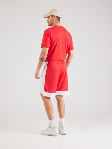 Champion Authentic Athletic Apparel - Loosefit Calças em vermelho
