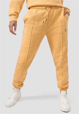 Karl Kani Regular Pants in Orange: front