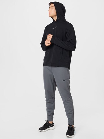 NIKE - Tapered Calças de desporto em cinzento