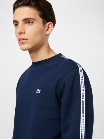 LACOSTE Sweatshirt i blå