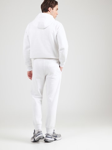 Effilé Pantalon 'CLUB' Nike Sportswear en beige