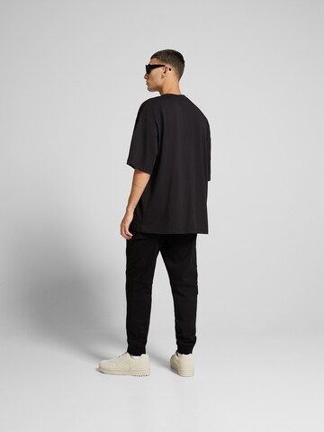 Bershka Tapered Cargo trousers in Black