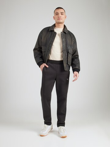 PUMA Regularen Športne hlače 'Evostripe' | črna barva