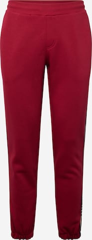 Tapered Pantaloni di TOMMY HILFIGER in rosso: frontale