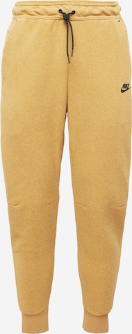 Nike Sportswear Tapered Trousers in Yellow: front