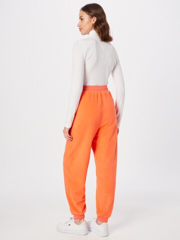 Tommy Jeans Zwężany krój Spodnie w kolorze pomarańczowy