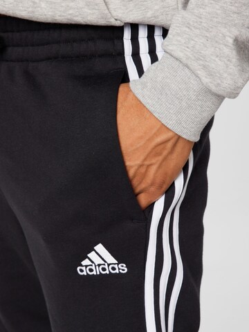 ADIDAS SPORTSWEAR Tapered Workout Pants 'Essentials Fleece Tapered Elastic Cuff 3-Stripes' in Black