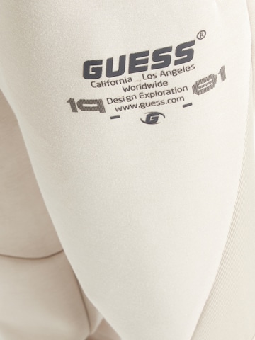 GUESS Tapered Παντελόνι φόρμας 'RYOTA' σε καφέ