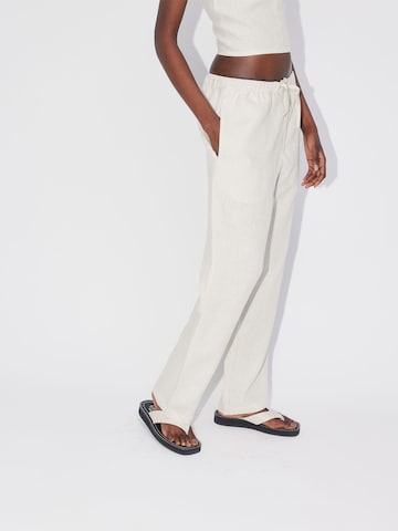 ABOUT YOU REBIRTH STUDIOS Wide leg Pants 'Holiday' in Beige