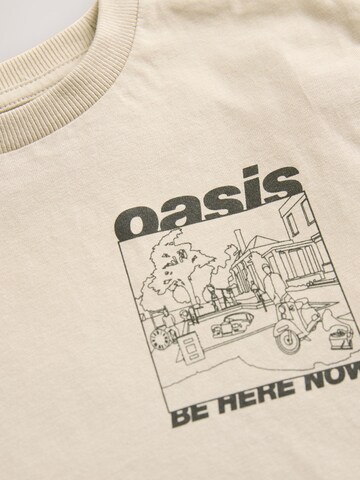 Tricou de la Next pe bej