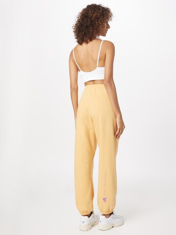 Loosefit Pantaloni sportivi di ADIDAS BY STELLA MCCARTNEY in giallo