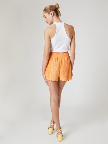 ABOUT YOU x Laura Giurcanu Loose fit Pants 'Betty' in Orange