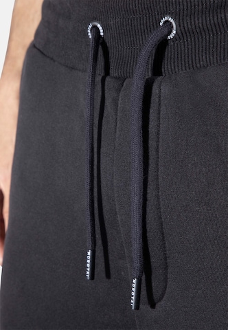 Effilé Pantalon de sport 'Corporate' MOROTAI en noir