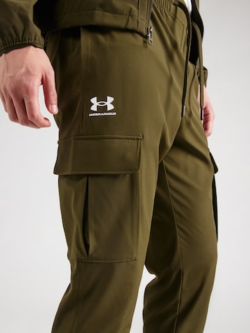 Effilé Pantalon de sport 'Vibe' UNDER ARMOUR en vert