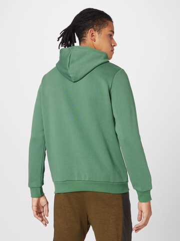 PUMA Sports sweatshirt 'ESSENTIAL' in Green