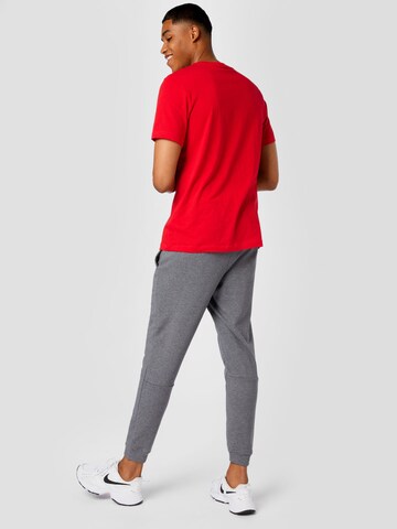 NIKE - Tapered Calças de desporto em cinzento