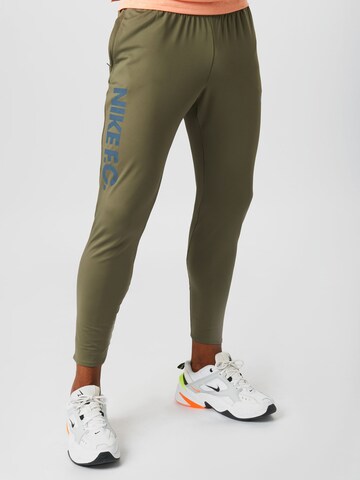 NIKE Slim fit Workout Pants in Green: front