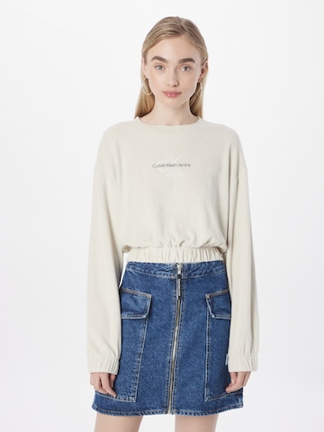 Calvin Klein Jeans كنزة رياضية بلون بيج: الأمام