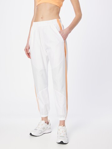 UNDER ARMOUR Tapered Sports trousers in White: front