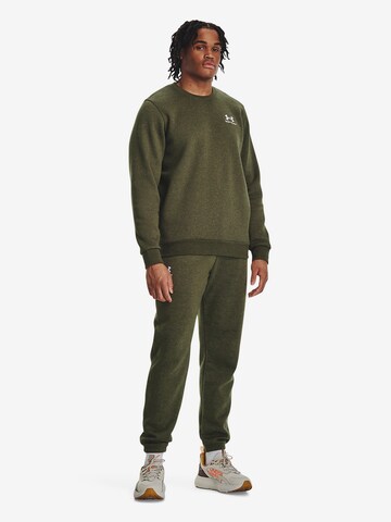 UNDER ARMOUR Tapered Sports trousers 'Essential' in Green