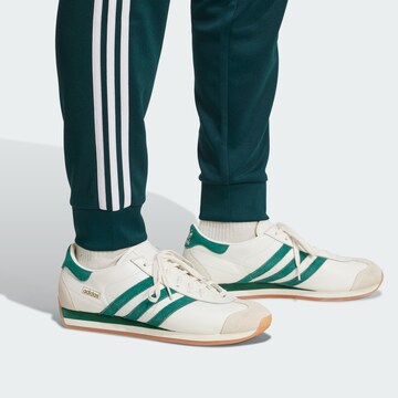 ADIDAS ORIGINALS Tapered Trousers in Green