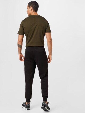 Effilé Pantalon de sport PUMA en noir