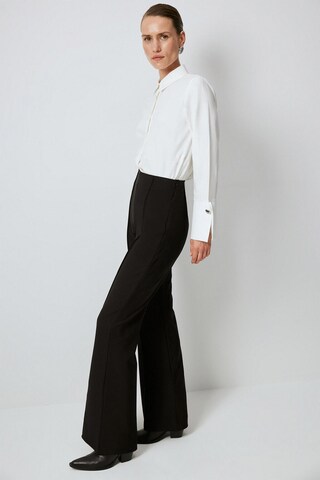 Touche Prive Flared Trousers in Black