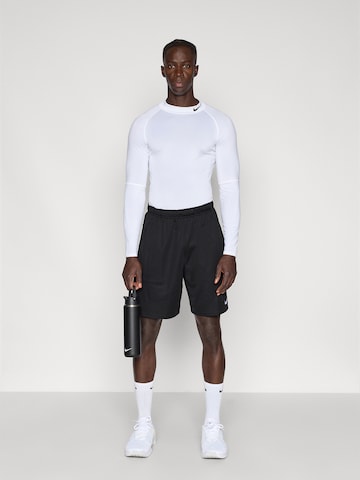 NIKE Loosefit Παντελόνι φόρμας 'FLEX' σε μαύρο