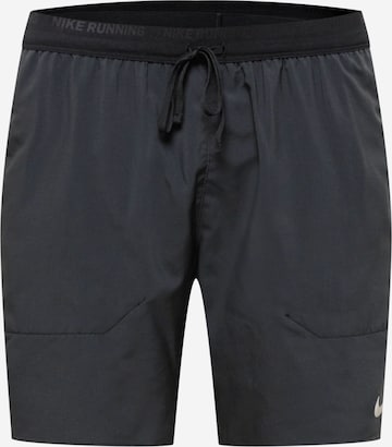 NIKE Regular Workout Pants in Black: front