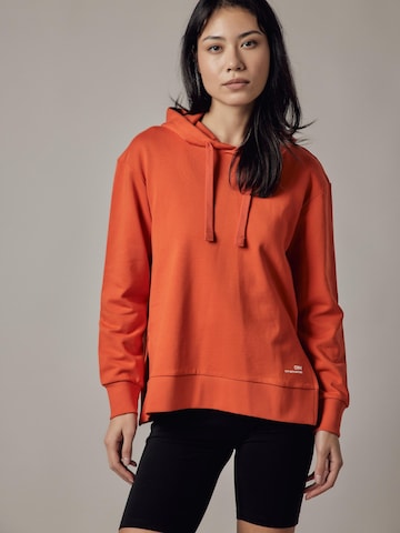 Felpa 'Felpa con Cappuccio e Spacchi Laterali' di OWN Off With Nature in arancione: frontale