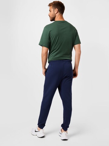 NIKE Tapered Workout Pants in Blue