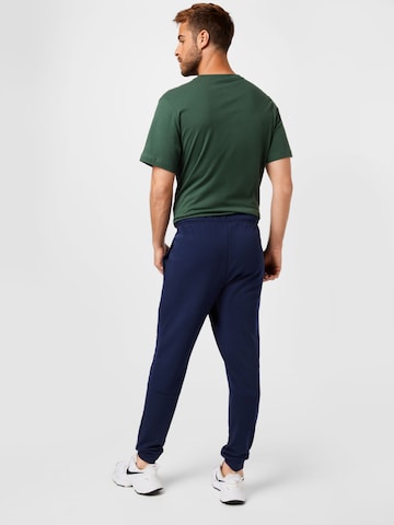 NIKE Tapered Sportsbukser i blå