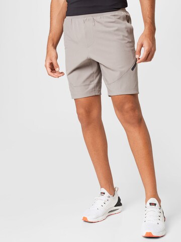 Regular Pantalon de sport UNDER ARMOUR en gris : devant