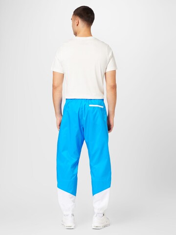 Nike Sportswear Tapered Broek in Blauw