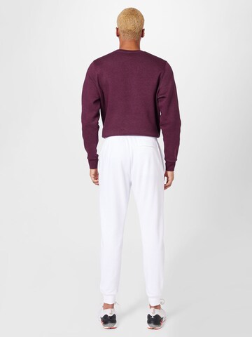 UNDER ARMOUR - Tapered Pantalón deportivo en blanco